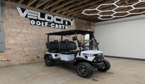 Fresh Powder White Voyager Commander 4 seater forward-facing golf cart with black seats and Eco lithium battery, lifted with independent suspension and four-wheel disc brakes at Velocity Golf Carts in Salt Lake City, Utah