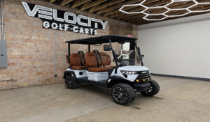 Fresh Powder White Voyager Commander 4 seater forward-facing golf cart with brown seats and Eco lithium battery, lifted with independent suspension and four-wheel disc brakes at Velocity Golf Carts in Salt Lake City, Utah