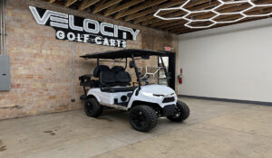 Fresh Powder White Voyager Patriot 4 passenger golf cart with black seats, 72-volt Eco lithium battery, independent suspension, four-wheel disc brakes, lifted suspension, Apple CarPlay, and aluminum frame at Velocity Golf Carts in Salt Lake City, Utah
