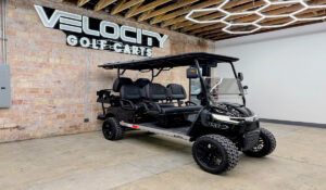 Night Sky Black Voyager Patriot 6 passenger golf cart with black seats, 72-volt Eco lithium battery, independent suspension, four-wheel disc brakes, lifted suspension, Apple CarPlay, and aluminum frame at Velocity Golf Carts in Salt Lake City, Utah
